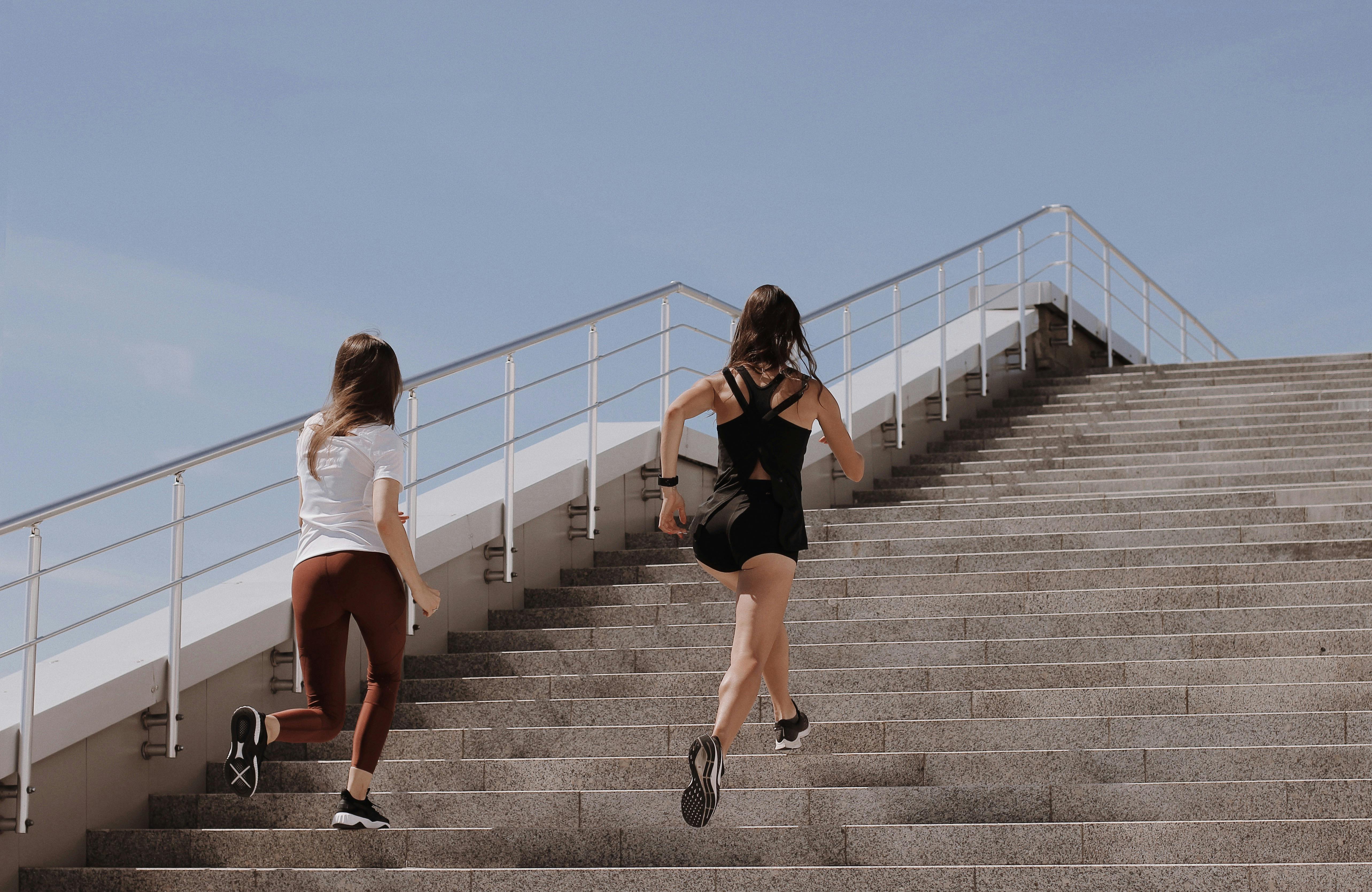 Two women running up the stairs